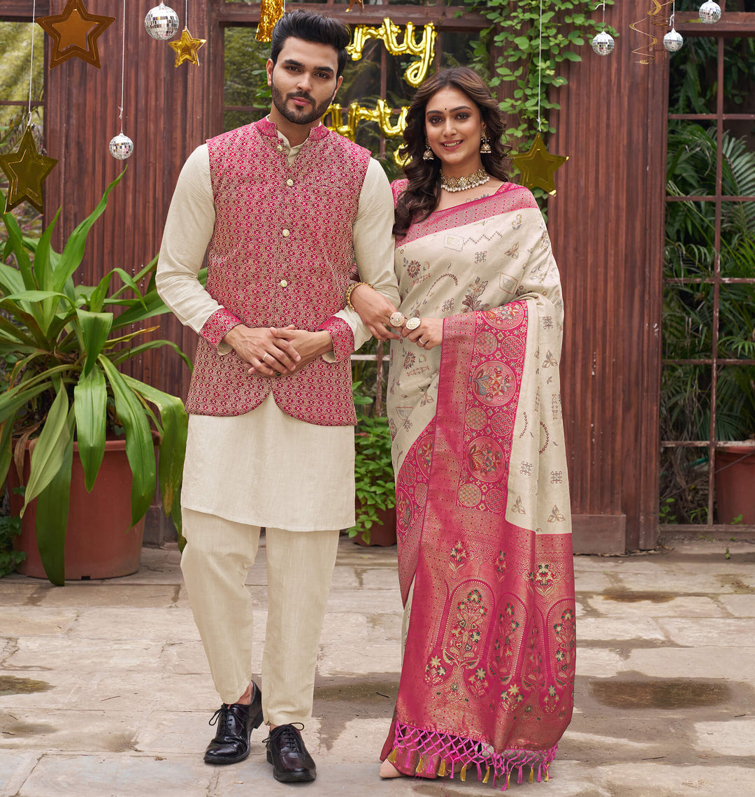 Man and woman in traditional attire standing together with festive decorations in the background.